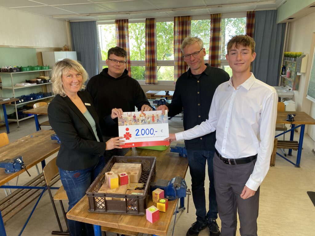 Geld für einen 3D-Drucker. Tanja Schleusner (ganz links) und Mark Lüpke (ganz rechts) von der Sparkasse Vorpommern übergeben Fynn Venzmer (2.v.l.) und Maik Köhnke (2.v.r.) den Scheck für die Neuanschaffung an der Gingster Schule. Foto: Martina Zabel